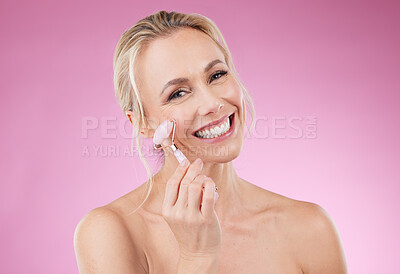 Buy stock photo Beauty, facial roller and woman portrait for face massage with dermatology and cosmetics in studio. Happy aesthetic person on pink background for skincare, self care and rose quartz results for glow