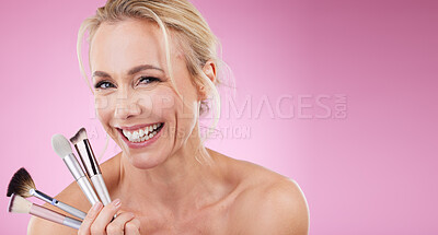 Buy stock photo Portrait, makeup brush or mockup with a mature woman in studio on a pink background to promote a cosmetic product. Face, happy or cosmetics with an attractive older female posing for beauty treatment