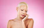 Black woman, beauty and skincare of a young person with hand on face from spa wellness. Isolated, pink background and studio of a female model feeling relax from dermatology, cosmetics and makeup 