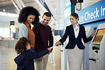 Woman, passenger assistant and family at airport by self service check in station for information, help or FAQ. Happy friendly female agent helping travelers register or book airline flight ticket