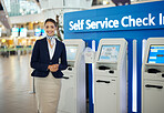 Woman, passenger assistant and airport by self service check in station for information, help or FAQ. Portrait of happy female services agent standing ready to assist people in travel destination