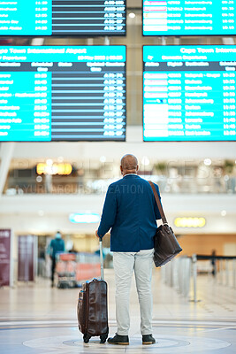 Buy stock photo Black man in airport, flight schedule display and waiting in terminal for international business trip from back. Visa, travel and luggage, businessman checking international destination boarding time