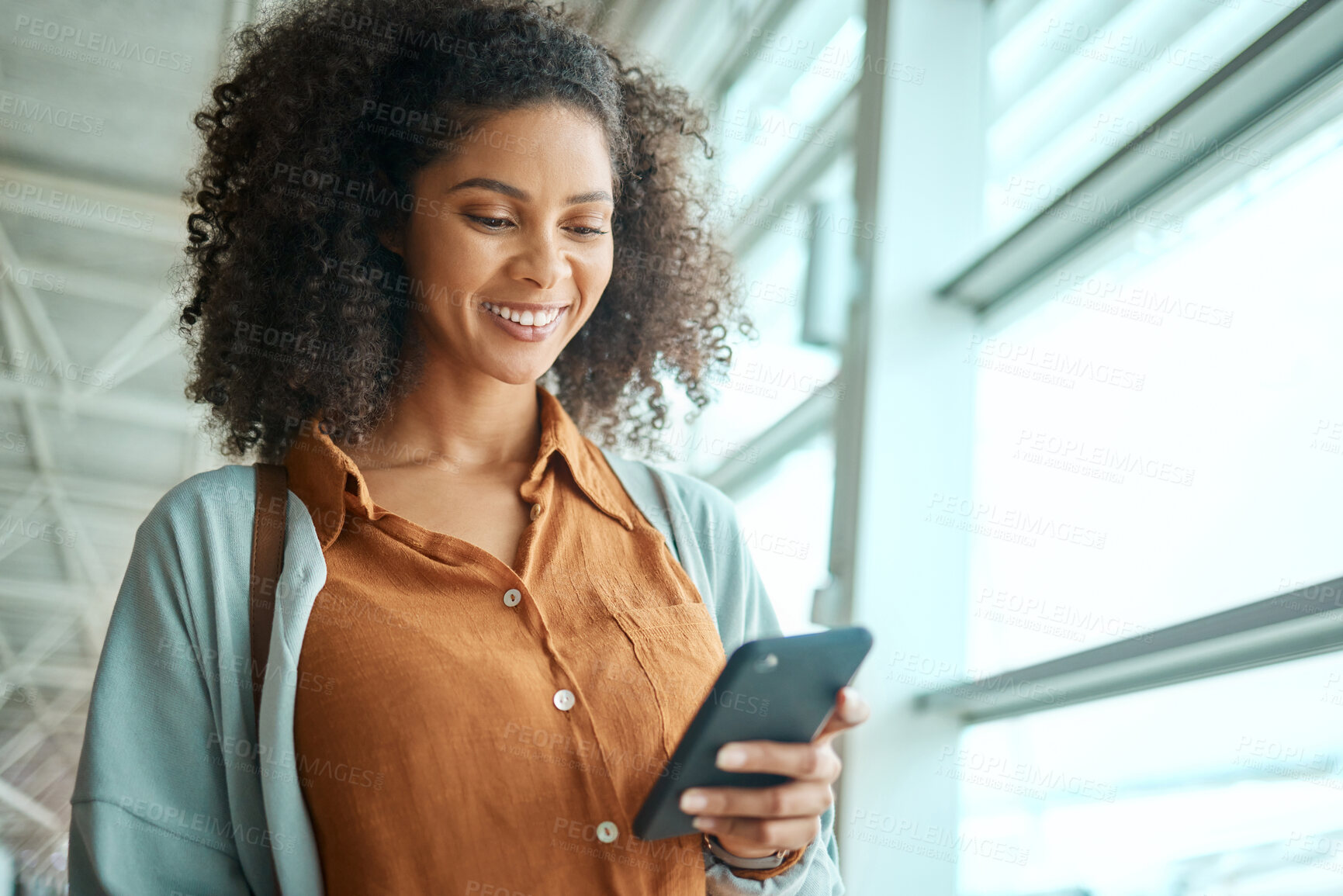 Buy stock photo Black woman at airport, travel with phone and communication and check social media with smile on face. Notification, email or chat with technology, ready for flight and happy for adventure