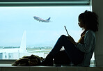 Airport, travel and black woman online with tablet by window waiting for flight, departure and transport. International plane, lobby and girl with digital tech for internet, schedule and social media