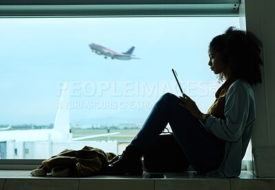 Buy stock photo Airport, travel and black woman online with tablet by window waiting for flight, departure and transport. International plane, lobby and girl with digital tech for internet, schedule and social media