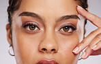 Eyes, vision and beauty with contact lenses and black woman, eye care and cosmetics with closeup on studio background. Microblading, eyebrow and lashes, face and hand in portrait with manicure