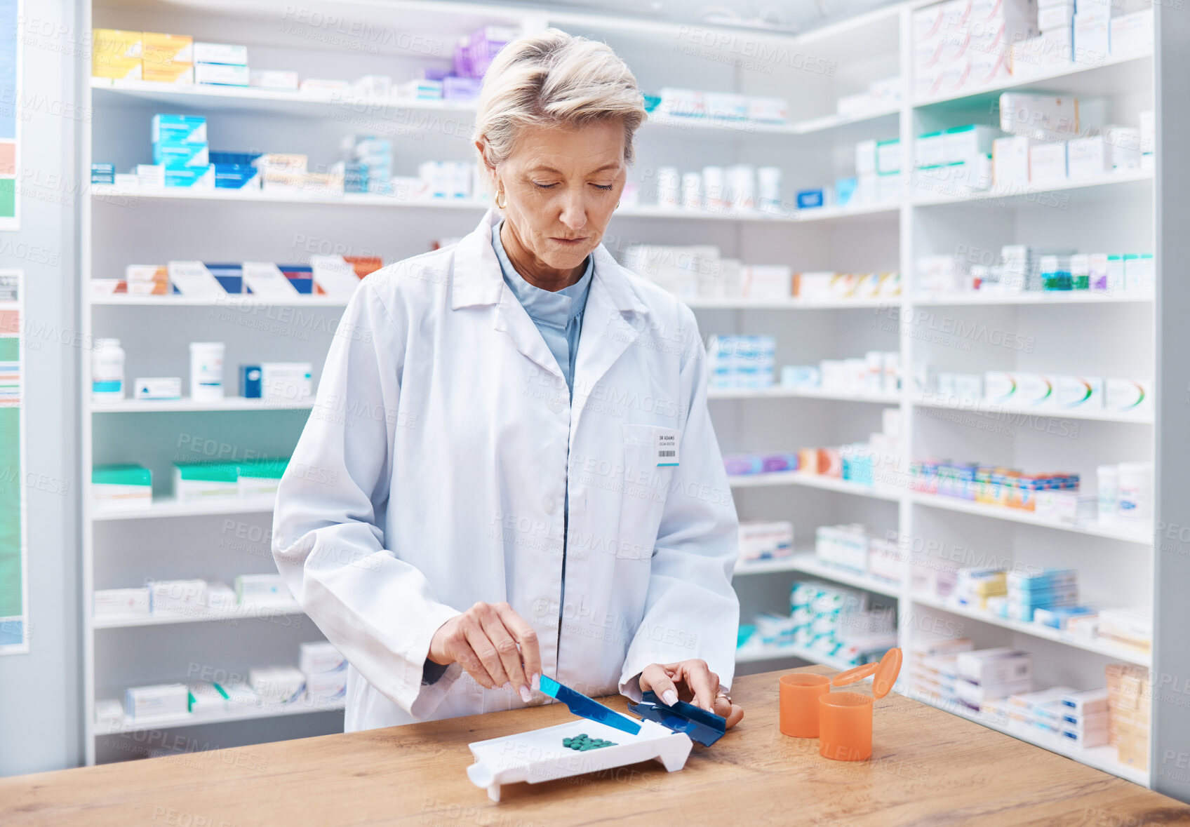 Buy stock photo Pharmacy woman, pills and counting in store for stock, product and medicine for health on table with tools. Pharmacist sorting, management and focus for retail pharma for healthcare service in shop