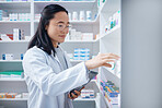 Tablet, Asian woman and pharmacist stock check in pharmacy for healthcare medicine in drugstore. Medication, technology or young female medical doctor with touchscreen for checking inventory in shop.