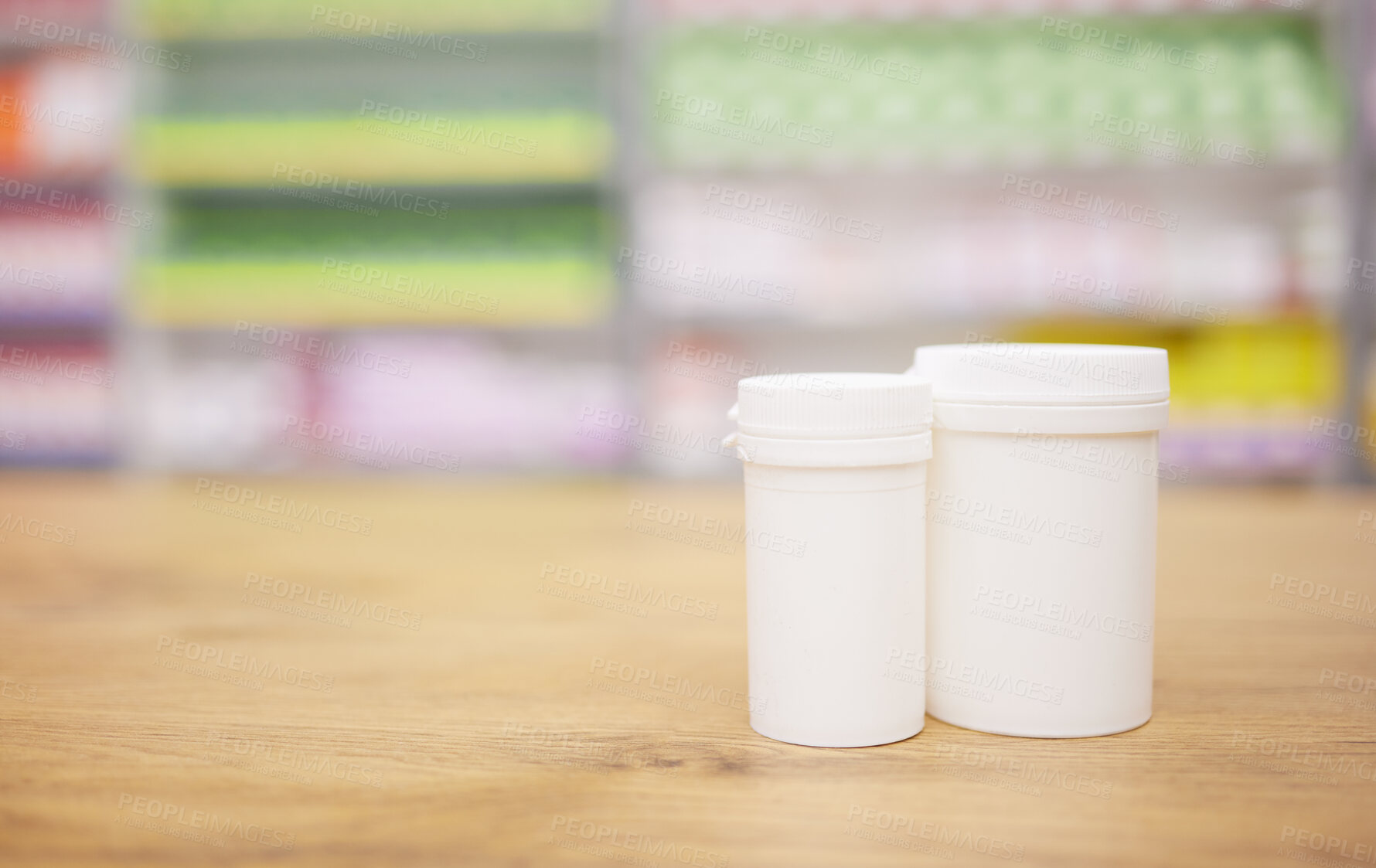 Buy stock photo Pharmacy, medicine and mockup with a tablet containers for pills on a wooden countertop for treatment. Medical, insurance and healthcare in a drugstore with mock up for pharmaceutical advertising