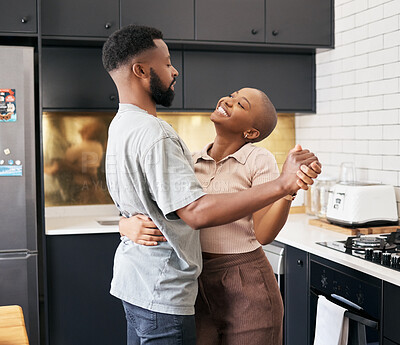 Buy stock photo Dance, love and happy black couple in the kitchen having fun together in their new modern home. Happiness, smile and young African man and woman dancing for romantic or intimate moment in their house