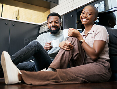 Buy stock photo Relax, smile and portrait of a couple with coffee on the kitchen floor in the morning. Love, happy and black man and woman drinking a cup of tea, latte or warm beverage with conversation together