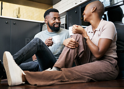 Buy stock photo Relax, talking and an African couple with coffee on the kitchen floor in the morning. Love, happy and black man and woman drinking a cup of tea, latte or warm beverage with conversation together