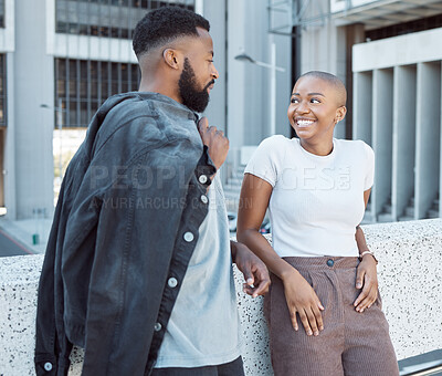 Buy stock photo Talking, black people and couple of friends in a city with happiness and conversation outdoor. Urban lifestyle, happy woman and communication by a building with partner and smile from discussion