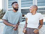 Conversation, black people and happy couple of friends in a city with happiness outdoor. Urban lifestyle, laughing woman and communication by a building with partner and smile from discussion