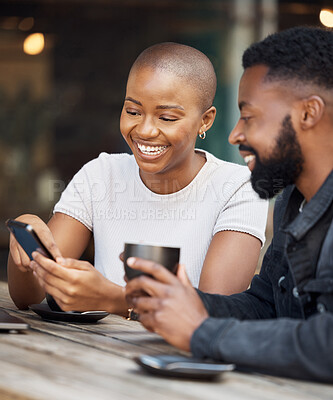 Buy stock photo Coffee shop, social media and dating with a black couple laughing together at a table in a restaurant. Humor, love or date with a man and woman looking at a meme on a phone while bonding in a cafe