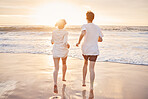 Couple at beach, running to ocean with travel and freedom outdoor, love and care in relationship with youth. Care free at sunset, nature and sea waves with young people back view on holiday in Hawaii