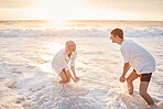 Couple at beach, splash in water with sea, travel and freedom outdoor, love and care in relationship with youth. Cafe free at sunset, nature and ocean waves with young people on holiday in Hawaii