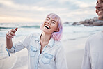 Happy, beach and vacation with a couple walking on the sand together by the ocean or sea for fun. Smile, humor or joking with a woman and man enjoying a funny joke while bonding on the coast