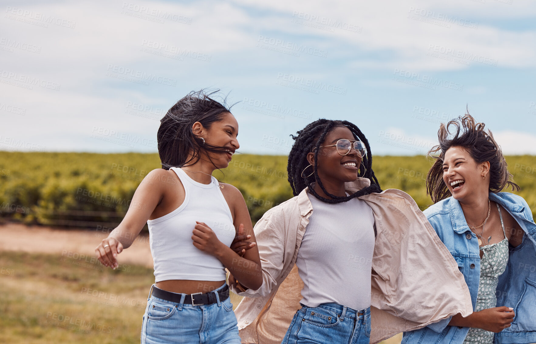 Buy stock photo Women, friends and countryside for outdoor adventure, holiday and together for summer sunshine. Group, happy black woman and gen z students on vacation with comic laugh, support and walking in nature