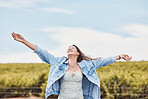 Happy, freedom and smile with woman in nature for peace, relax and youth with blue sky mockup. Journey, adventure and happiness with girl enjoying outdoors for summer break, vacation and holiday