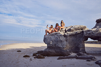 Buy stock photo Friends, beach and selfie for diversity on a rock outdoor for holiday or vacation in summer. Group of women together at sea or ocean for travel in Bali for freedom in nature with water and blue sky