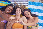 Friends, beach and women with heart for love and support on vacation, travel or holiday in summer. Above group together on towel for tropical, funny or comic time together with diversity and hands