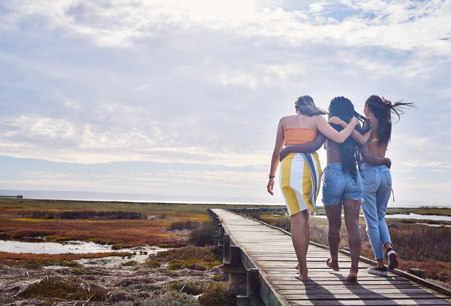 Buy stock photo Relax, group and boardwalk with friends at beach for travel vacation, support or summer break with blue sky mockup. Diversity, holiday and nature with women walking together for bonding, hug or peace