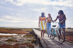 Travel, happy and bicycle with friends at the beach for summer break, bonding and relax with blue sky mockup. Peace, tropical and diversity with women on vacation for nature, smile and holiday