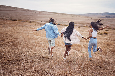 Buy stock photo Freedom, nature and run with woman friends together outdoor for adventure, fun or exploring the wilderness. Running, autumn and excited with a friend group playing outside while bonding from the back