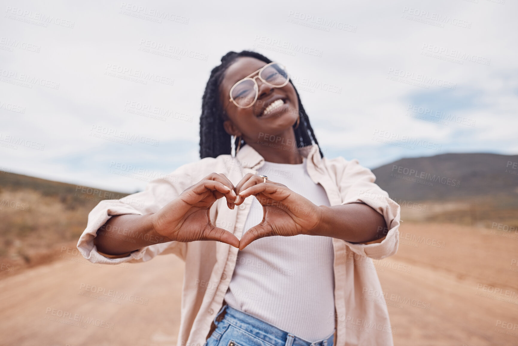 Buy stock photo Happy, heart and hands with portrait of black woman in desert for freedom, smile and travel. Relax, happiness and sign with girl and positive gesture in nature for emoji, confidence and proud