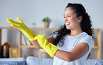 Cleaning, gloves and hygiene with a black woman cleaner in her home for housekeeping or chores. Hands, bacteria and health with a happy young female in a house working as a domestic housekeeper