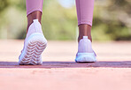 Runner athlete, woman and feet on pavement with blurred background ready for fitness and exercise. Road, run shoes and training of a female black person outdoor for sports, race and marathon