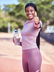 Fitness, portrait and black woman thumbs up with water for exercise, health and wellness goals outdoors. Sports training, motivation and happy female athlete with hand gesture for success or support.