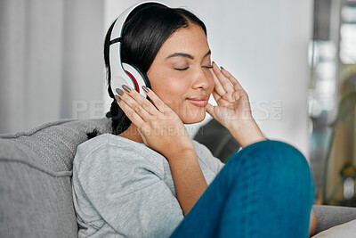 Buy stock photo Music, headphones and woman on sofa in home living room streaming radio or podcast. Relax, technology and female with headset for listening or enjoying song, audio or album on couch in house lounge.