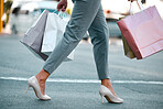 Shopping bags, woman customer and heels of a girl on a city street in New York with sale bag. Mall, retail fashion shop and store discount with a female walking outdoor after a luxury boutique visit
