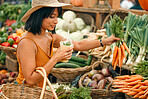 Vegetables, market and black woman shopping for grocery, natural and vegan food at small business. Farm supplier, carrot and young person or customer with basket for retail product, nutrition or diet