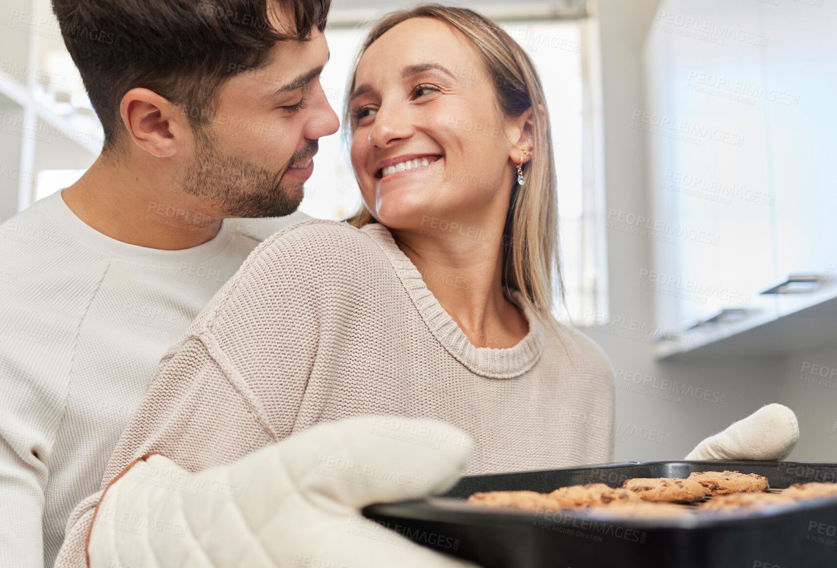 Buy stock photo Love, kitchen and couple baking cookies together for fun, bonding and romance in their home. Bake smile and happy young man and woman preparing biscuits or snacks for party, event or dessert at house