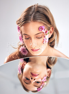 Buy stock photo Beauty face, mirror reflection and woman with flower product, sustainable agriculture and natural skincare. Facial makeup, nature plant cosmetics and eco friendly girl isolated on studio background