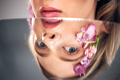 Buy stock photo Beauty, mirror face and model with flower product, sustainable agriculture and natural skincare reflection. Facial makeup, nature plant cosmetics and eco friendly woman isolated on studio background
