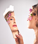 Beauty, reflection and portrait of a woman with a broken mirror for an insecurity and problem. Mental health, makeup and face of a girl getting ready and looking at face isolated on a background