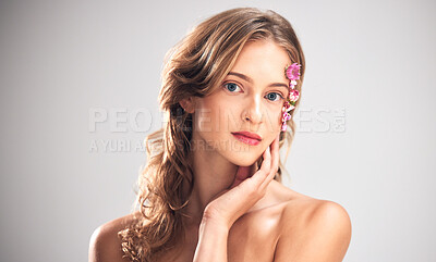 Buy stock photo Beauty flowers, face portrait or woman with floral product, sustainable agriculture and relax natural skincare. Facial makeup, nature plant cosmetic or eco friendly girl isolated on studio background