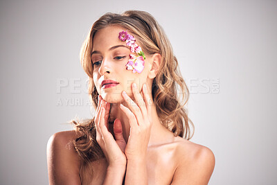 Buy stock photo Beauty, flower and face of woman in studio for natural cosmetics, skincare wellness and makeup. Spring, art and girl with petals for spa aesthetic, luxury facial and self love on gray background