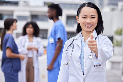 Buy stock photo Thumbs up, leadership and portrait of a female doctor standing outdoor of the hospital. Happy, smile and professional Asian woman healthcare worker with success or agreement gesture in medical clinic