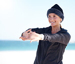Fitness, woman and stretching arms on beach in preparation for exercise, cardio workout or training. Happy sporty female in warm up arm stretch getting ready for fun exercising by the ocean on mockup