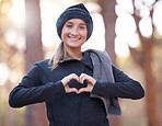 Portrait, heart hands and smile of woman hiking outdoors for wellness and fitness. Valentines day, love emoji and happy female with hand gesture for romance affection, support or empathy in winter.