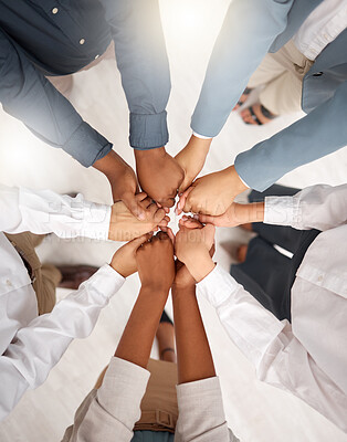 Buy stock photo Teamwork, diversity and group holding hands in circle for support, trust and team building together. Business people in huddle standing in solidarity at office workshop and commitment goal from above