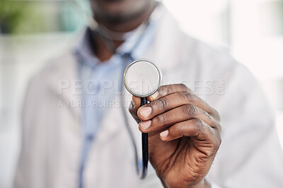 Hand, stethoscope closeup and doctor with help, healthcare service and black man in hospital. African medic, medical tools and close up for health, wellness and listening to heart, breathing and care