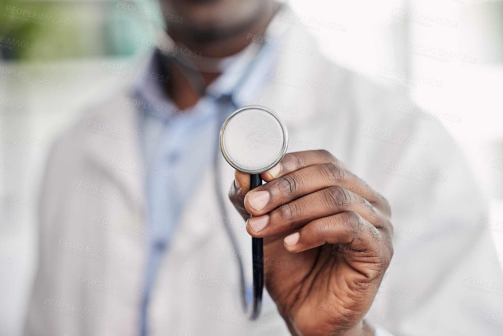 Buy stock photo Hand, stethoscope closeup and doctor with help, healthcare service and black man in hospital. African medic, medical tools and close up for health, wellness and listening to heart, breathing and care