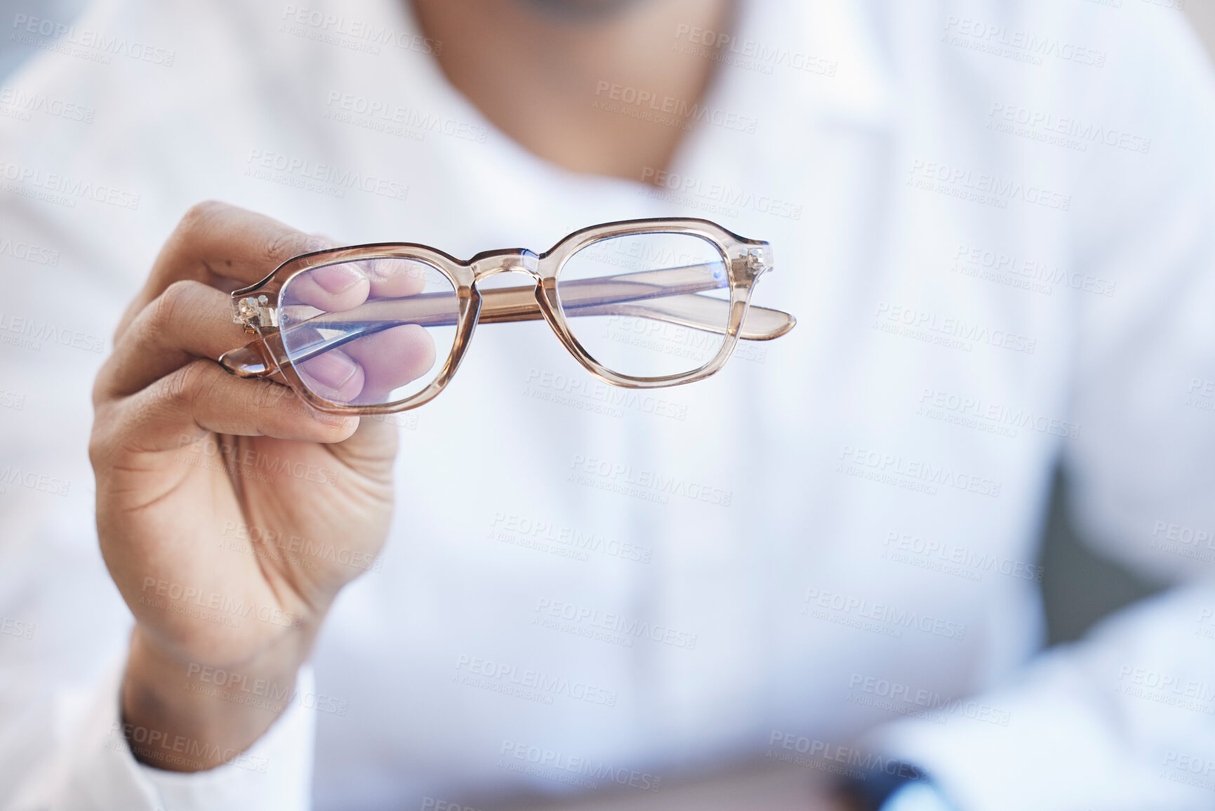 Buy stock photo Glasses, optometry and hand of optometrist holding spectacles, eyewear or specs for ophthalmology in an office. Person, eye care and doctor or professional with a vision frame by medical employee