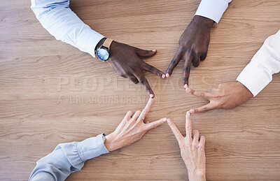 Buy stock photo Hands, star and collaboration overhead with a business team in the office sitting at a boardroom table. Hand sign, shape or teamwork with a man and woman employee group meeting for strategy at work